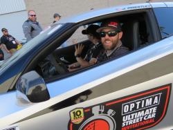 Picture of Jordan driving out of the Optima Alley heading to SEMA Ignited